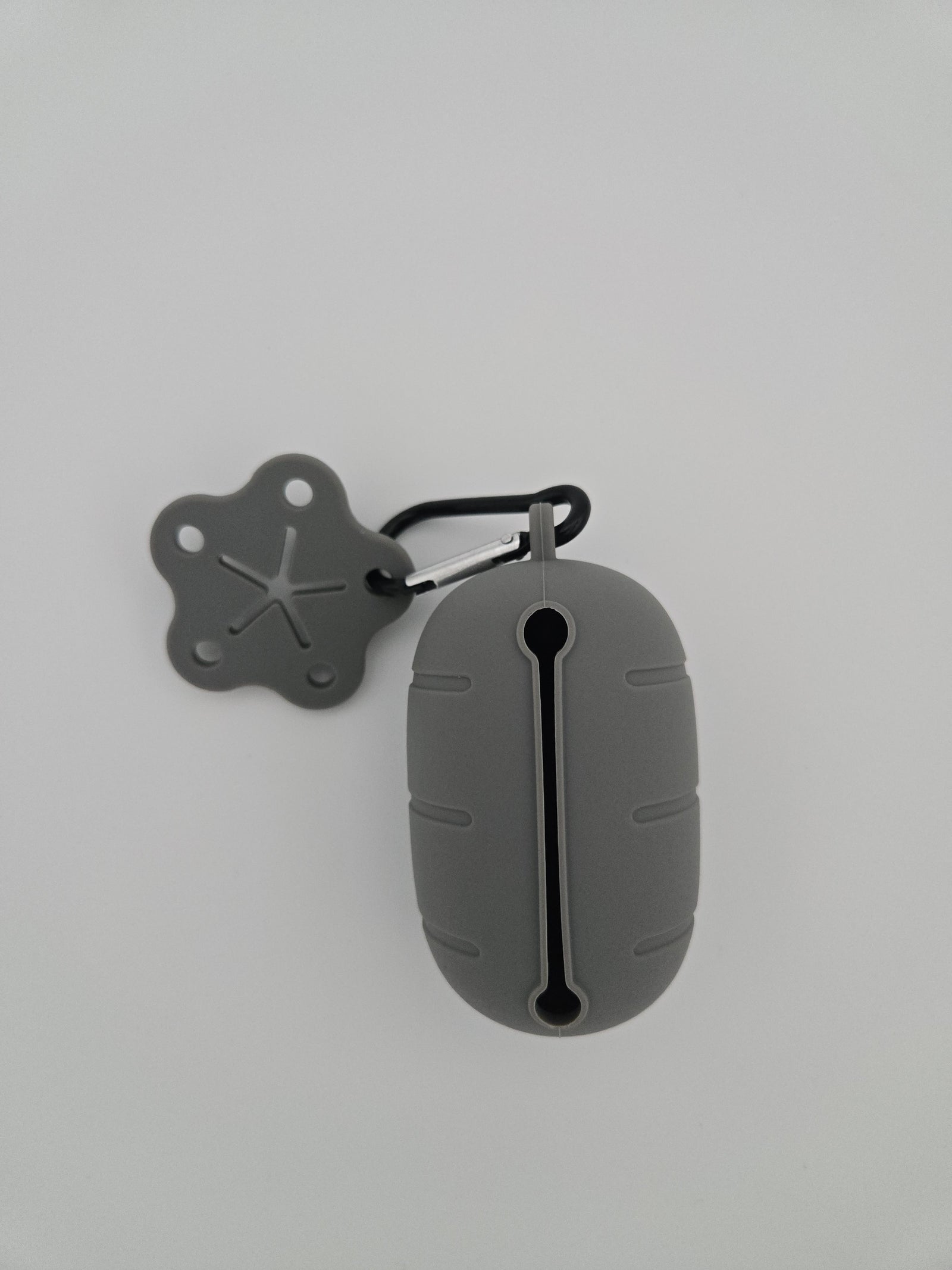 Grey silicone dog poop bag dispenser with carabiner clip and paw charm includes compostable 15 bag roll and 99% recycled 15 bag roll - alternate view