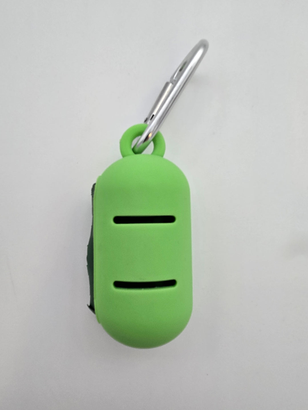 Green portable food grade silicone dog waste bag dispenser with clip comes with compostable and recycled rolls, shows leash slots