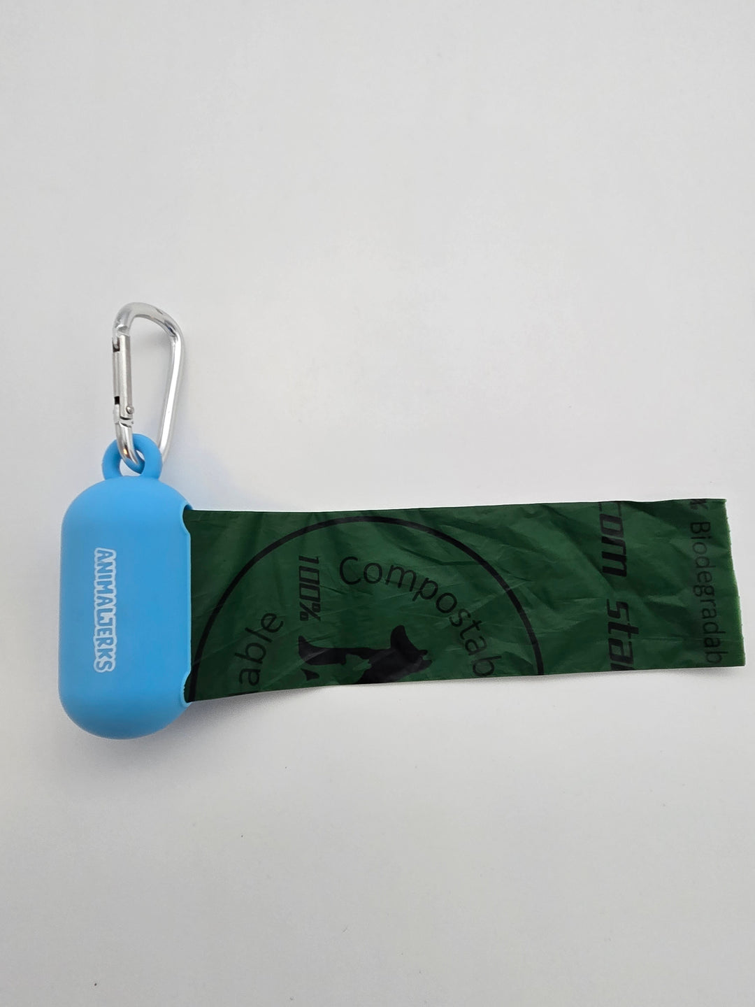 Blue portable food grade silicone dog waste bag dispenser with clip comes with compostable and recycled rolls, shows bag pulled out