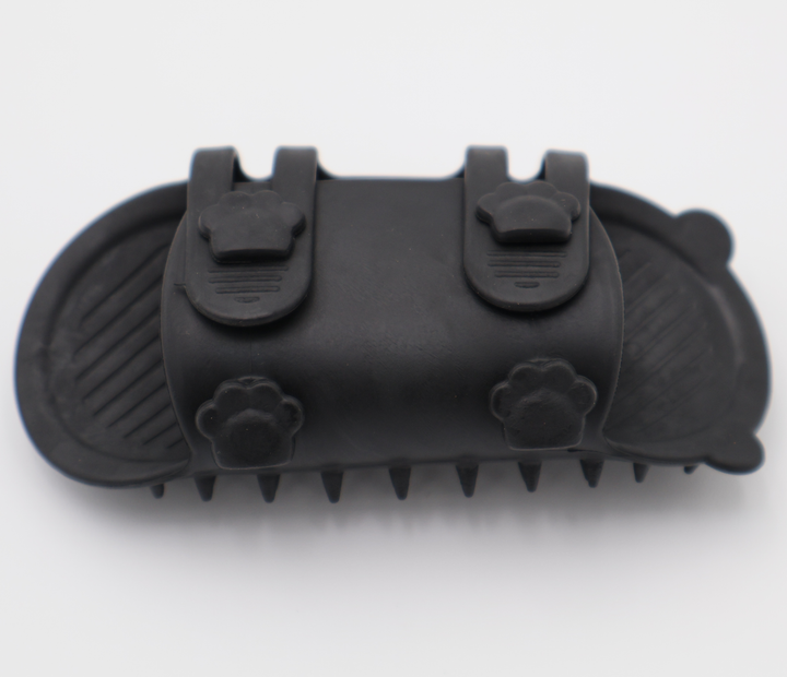 Black silicone cat grooming scratcher, underneath showing the two sizes if it was attached to a table leg. 