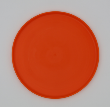 Orange food grade silicone flying disc for dogs soft flexible frisbee dishwasher safe durable, bottom view - thumbnail