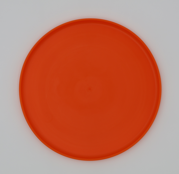 Orange food grade silicone flying disc for dogs soft flexible frisbee dishwasher safe durable, bottom view