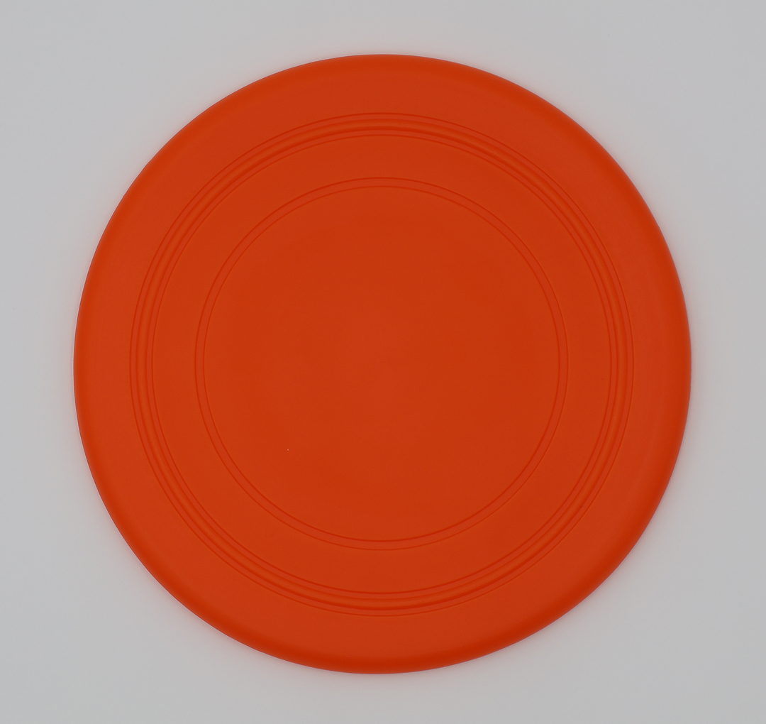 Orange food grade silicone flying disc for dogs soft flexible frisbee dishwasher safe durable, top view