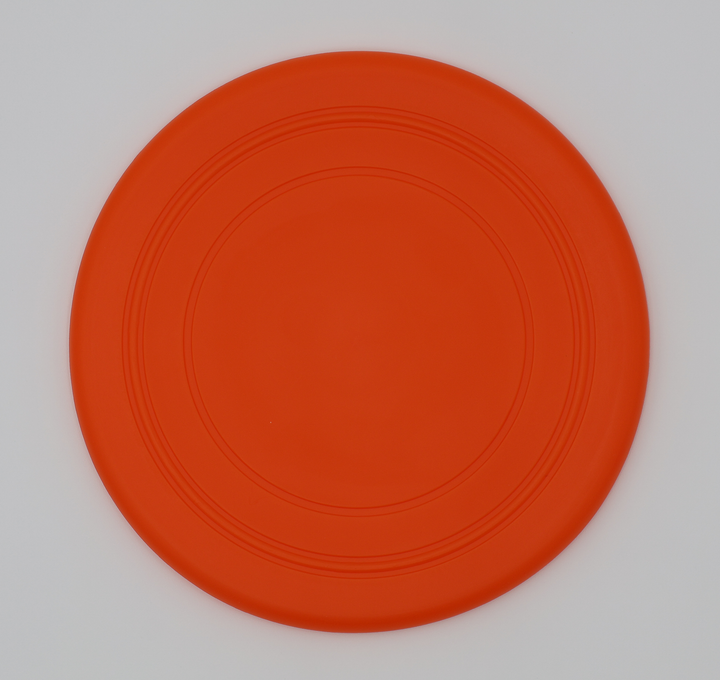 Orange food grade silicone flying disc for dogs soft flexible frisbee dishwasher safe durable, top view