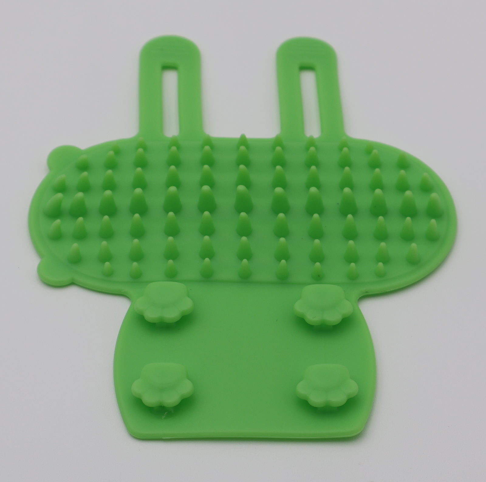 Green silicone cat grooming scratcher attaches to furniture legs two sizes