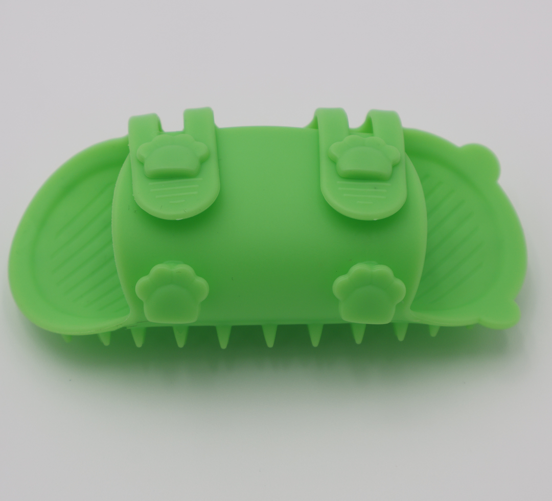 Green silicone cat grooming scratcher, underneath showing the two sizes if it was attached to a table leg. 
