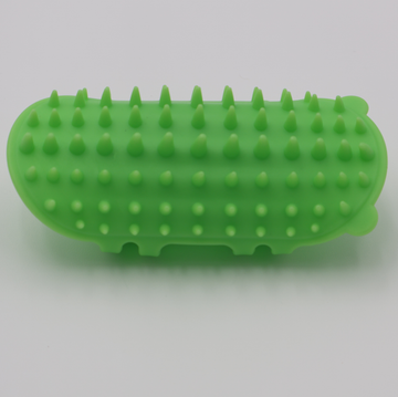 Green silicone cat grooming scratcher, showing what it would look like attached to a table leg. - thumbnail