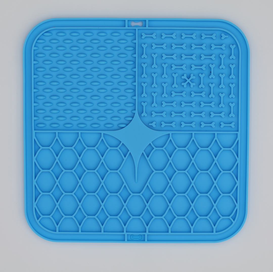 Blue food grade silicone dog licking mat with textured patterns for anxiety relief and slow feeding