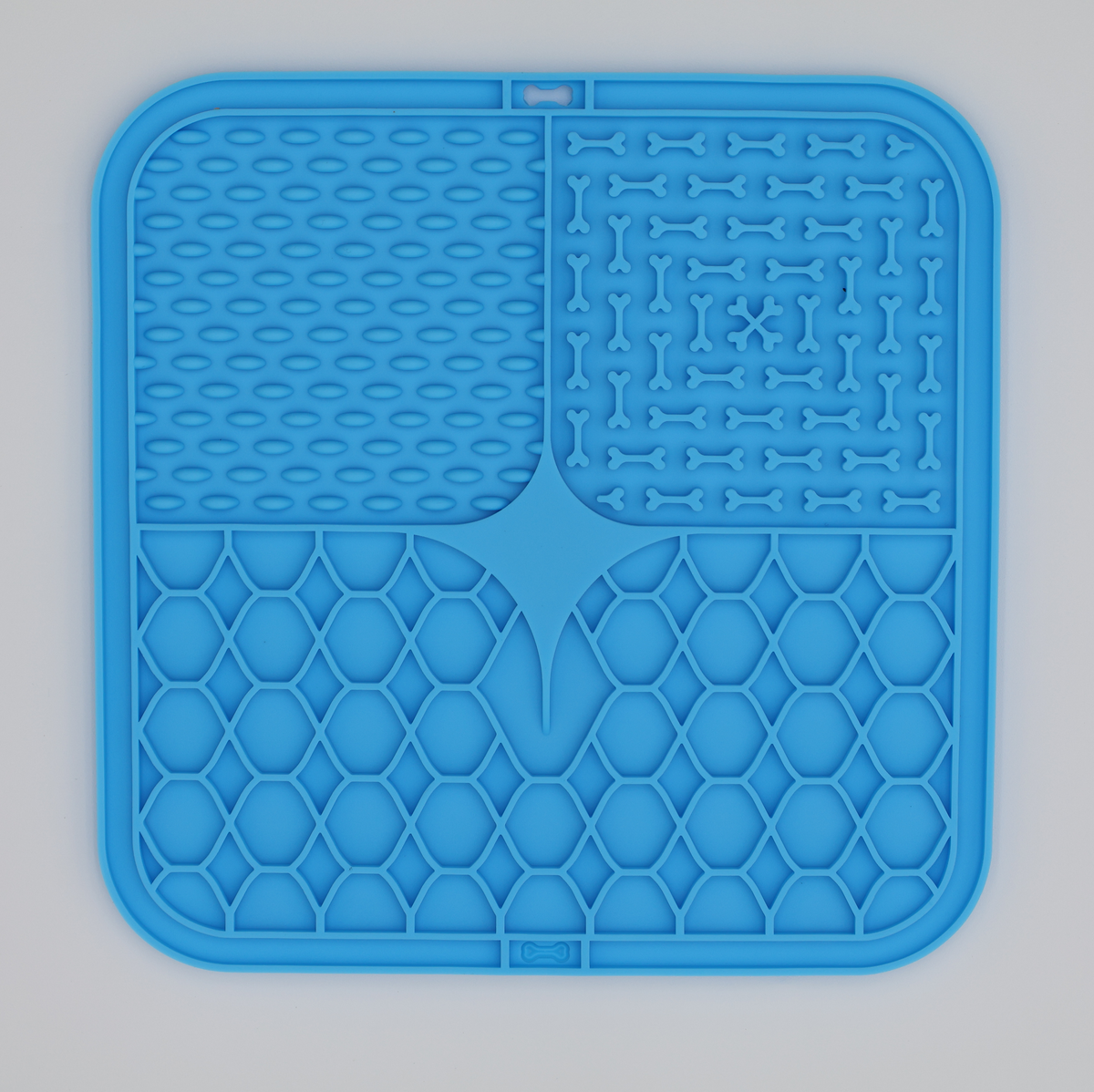 Blue food grade silicone dog licking mat with textured patterns for anxiety relief and slow feeding