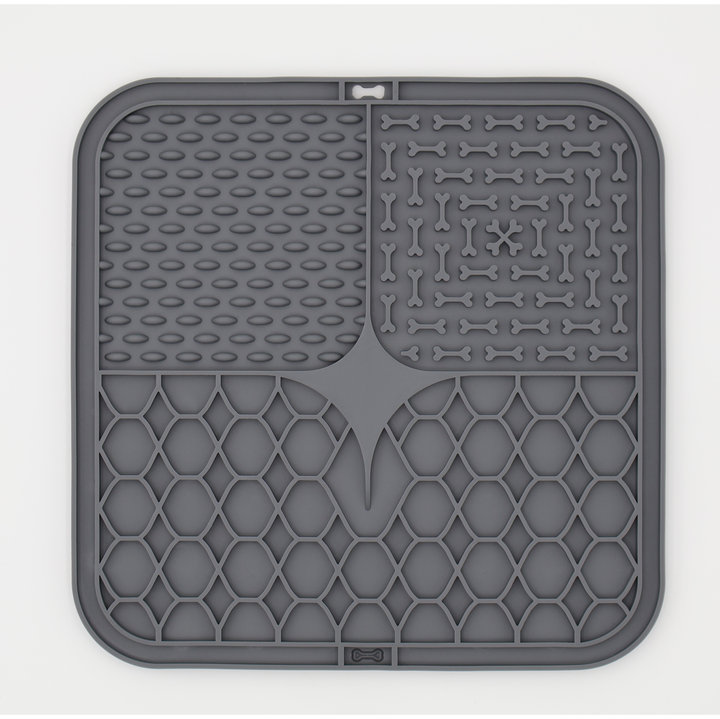 Grey food grade silicone dog licking mat with textured patterns for anxiety relief and slow feeding
