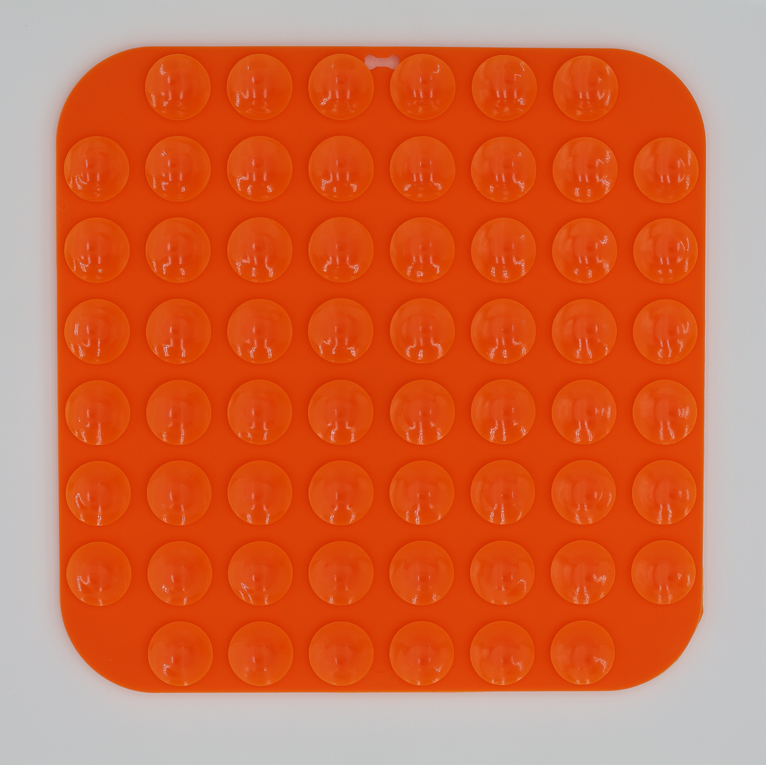 Orange food grade silicone dog licking mat underneath with suction cups