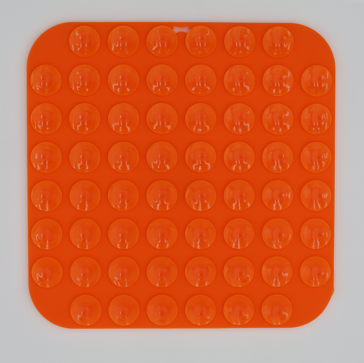 Orange food grade silicone dog licking mat underneath with suction cups