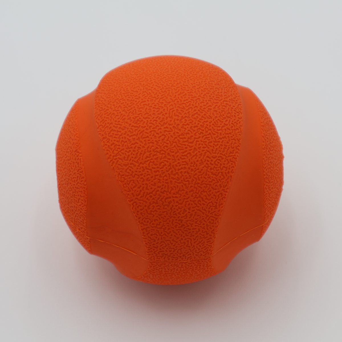 Orange treat dispensing dog ball with whistle sound food-grade silicone