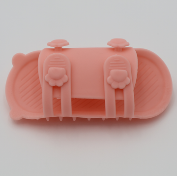 Pink silicone cat grooming scratcher, underneath showing the two sizes if it was attached to a table leg.  - thumbnail