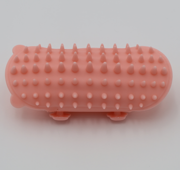Pink silicone cat grooming scratcher, showing what it would look like attached to a table leg. - thumbnail