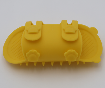 Yellow silicone cat grooming scratcher, underneath showing the two sizes if it was attached to a table leg.  - thumbnail