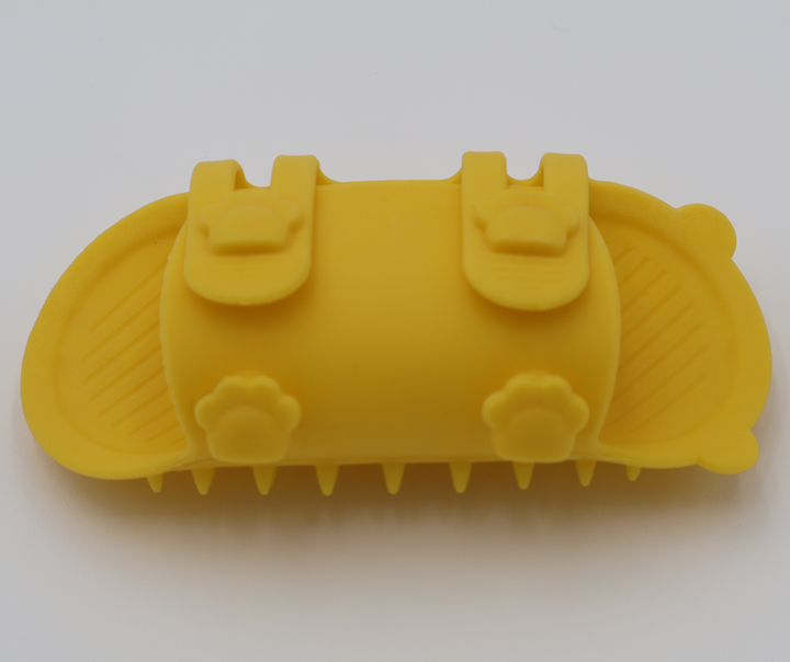 Yellow silicone cat grooming scratcher, underneath showing the two sizes if it was attached to a table leg. 